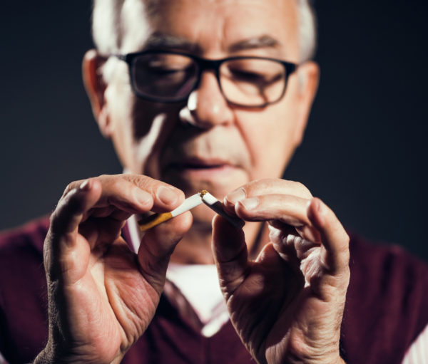 Close up image of senior man who is decided to quit smoking.