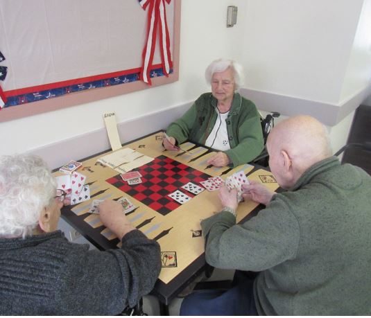 three seniors playing poker at Alden Long Grove